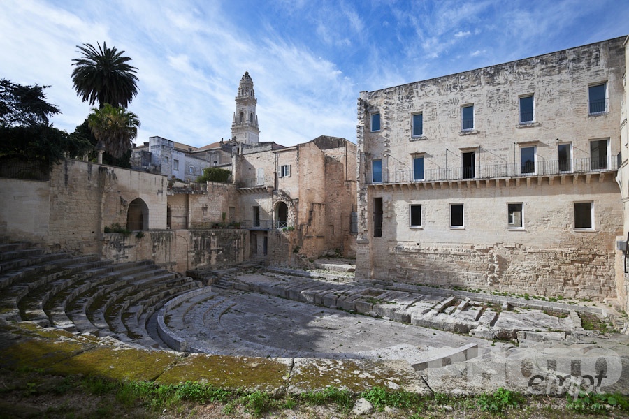 Italy South - Puglia. . . . . Panorama view of Greek amphitheatre with campanile of Duomo beyond, sunny spring morning with blue sky, Lecce, Salento, Puglia, Southern Italy