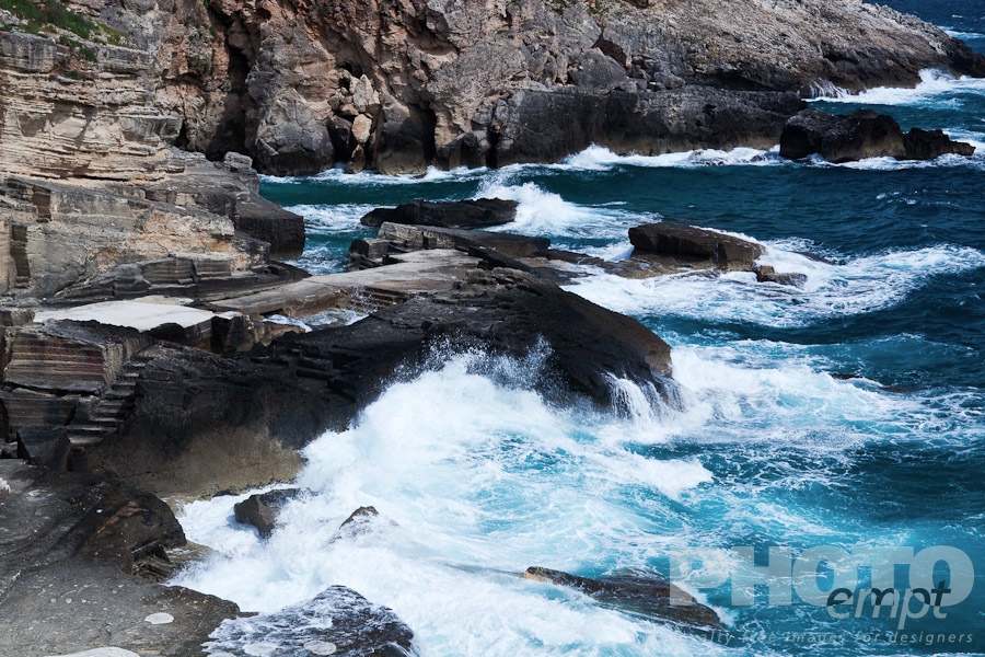 Italy South - Puglia. . . . . Detail of rocky cliffs, walls and stairways to open thermal baths of Santa Cesarea Terme, waves lashing rocks, Salento, Puglia, Southern Italy