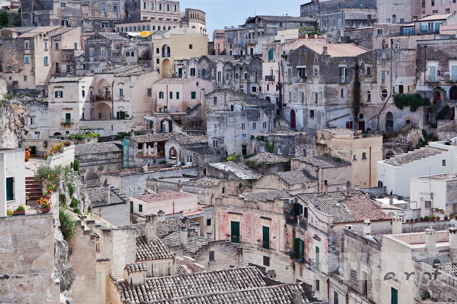 Italy South - Puglia. . . . . Aerial view of ancient town of Matera with tufa houses, sunny spring afternoon with blue sky, Puglia, Southern Italy