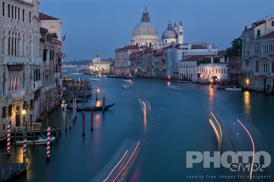 Venice in Autumn. . . . . Aerial view of Grand Canal, looking towards church of Santa Maria della Salute, multicoloured lines from motion blur of boat lights at twilight, looking beyond to San Marco Basin, Venice, Northern Italy